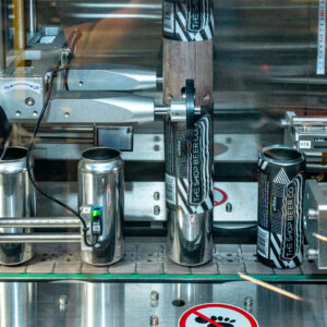Bare beer cans getting labeled